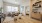living area with a couch, coffee table and large window in the background